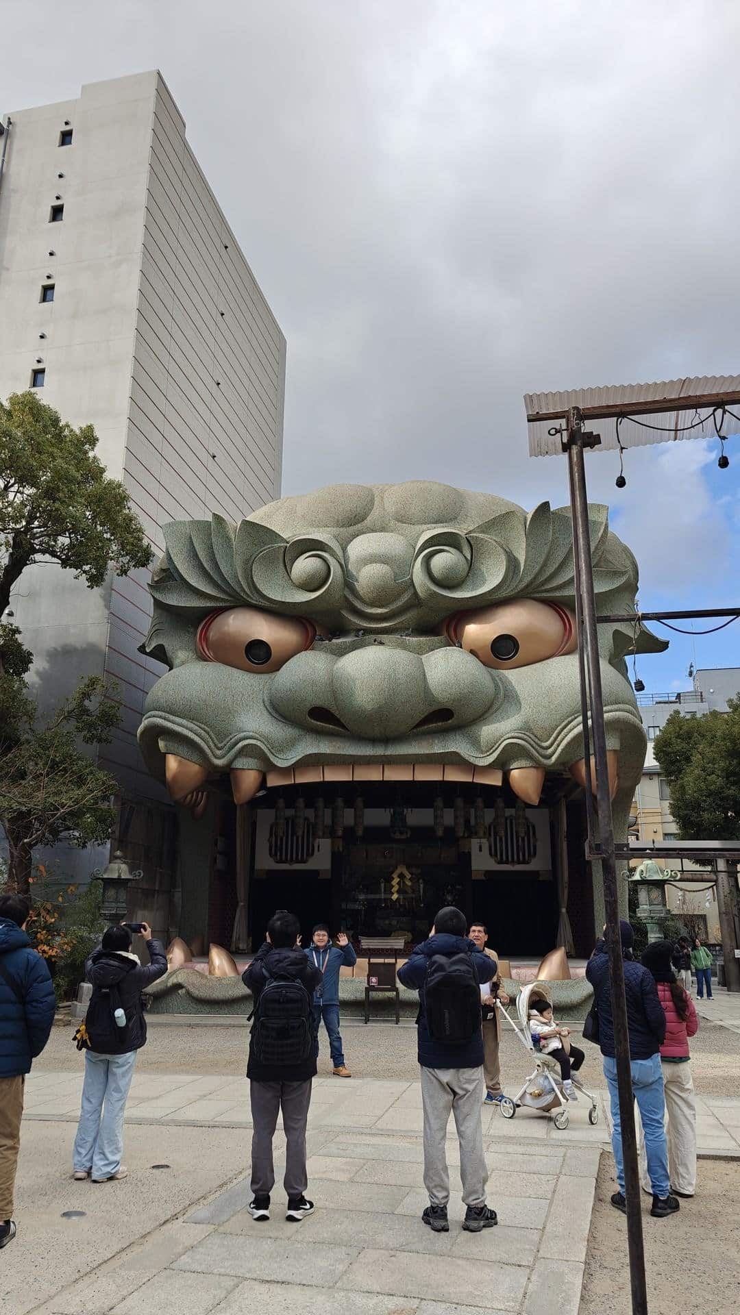 Dragon head temple entrance with visitors