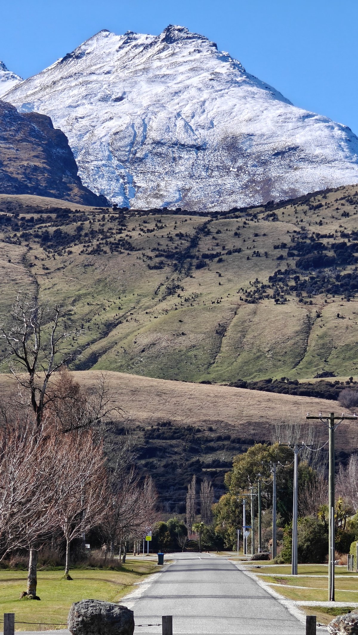 Dramatic snow-capped peak above lake