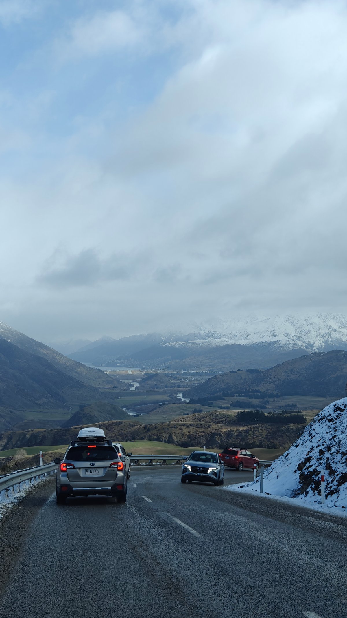 Driving snow-lined mountain road