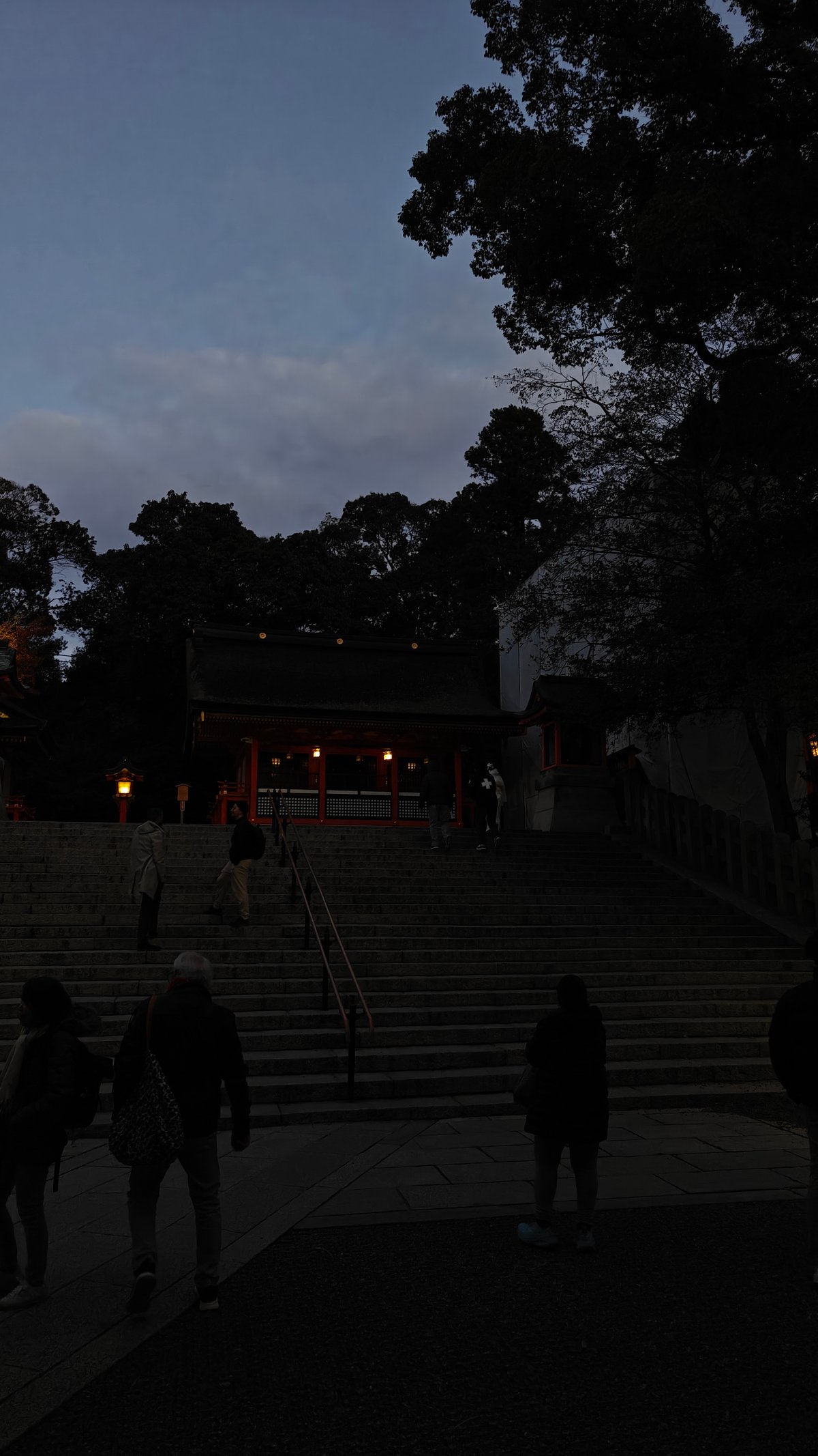 Dusk plaza and steps with silhouetted visitors