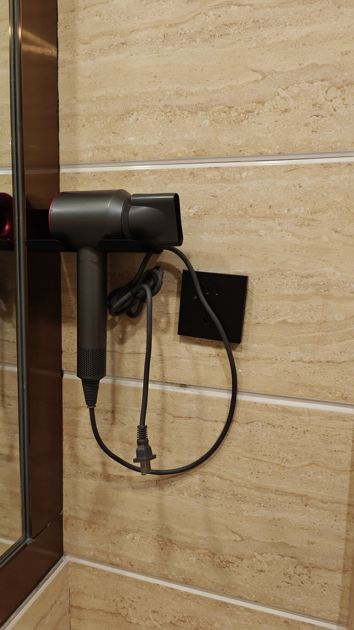 Dyson hair dryer on wall