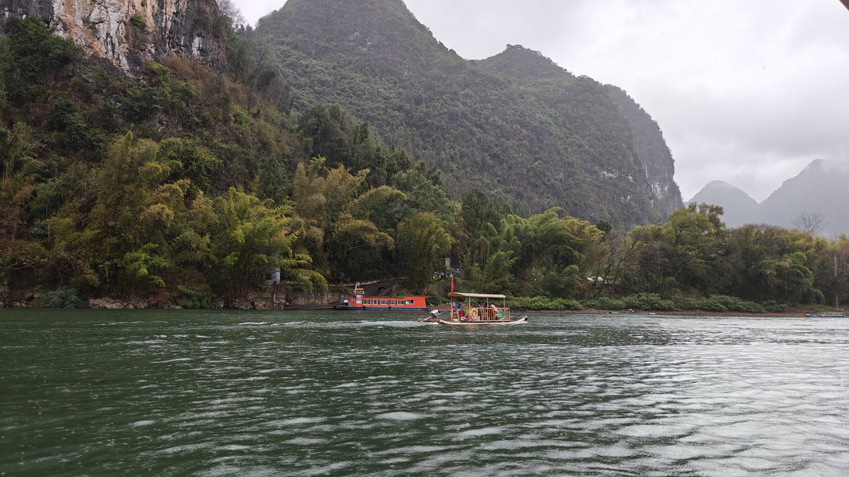 Early cruise past green riverbank
