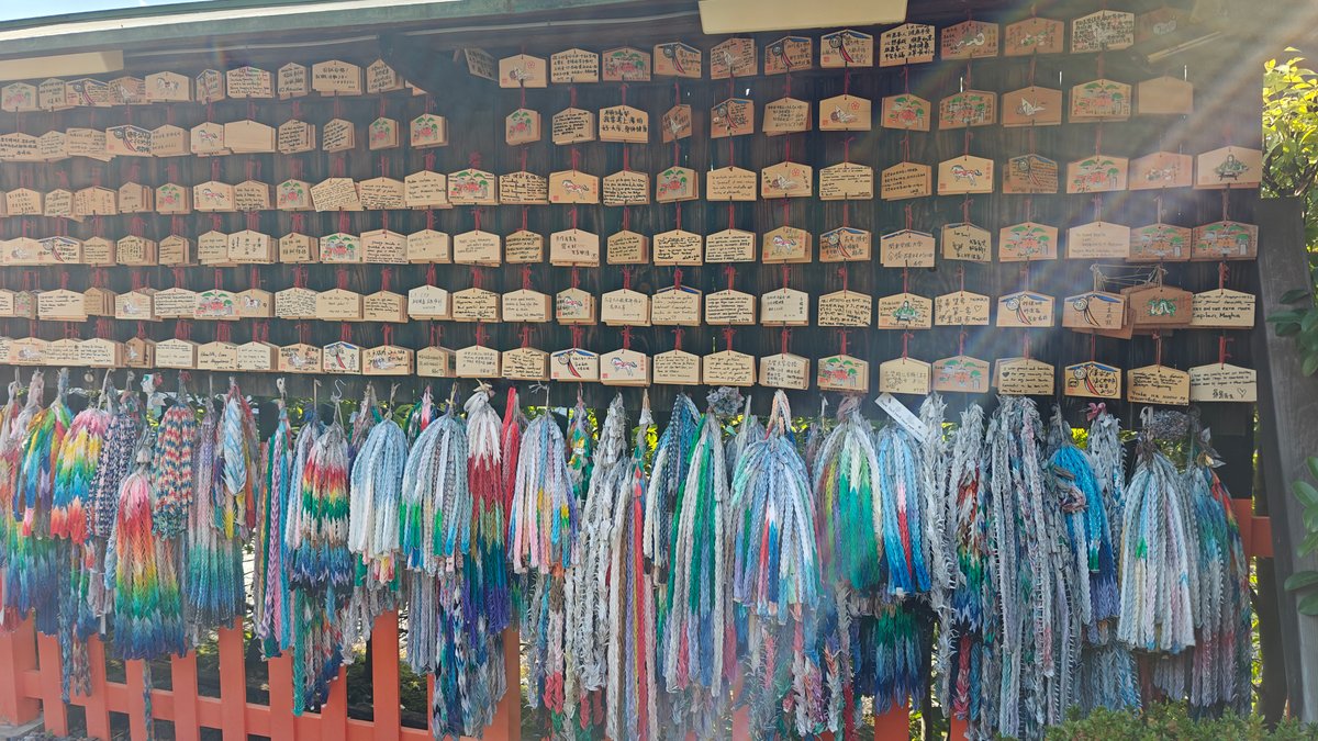 Ema plaque wall hung with colourful folded-paper cranes