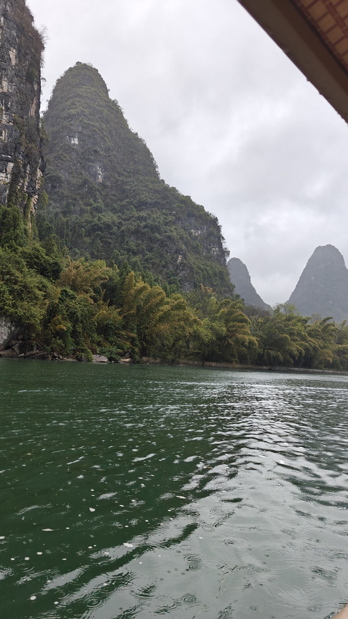 Emerald water and steep green peak