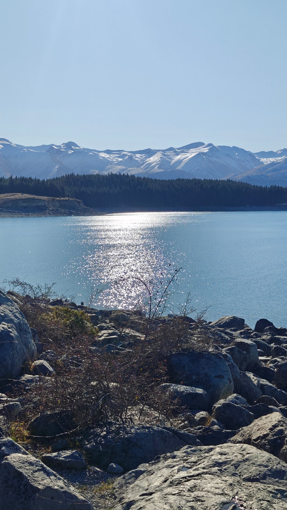 Establishing scenic: mid-afternoon sun glinting silver on the