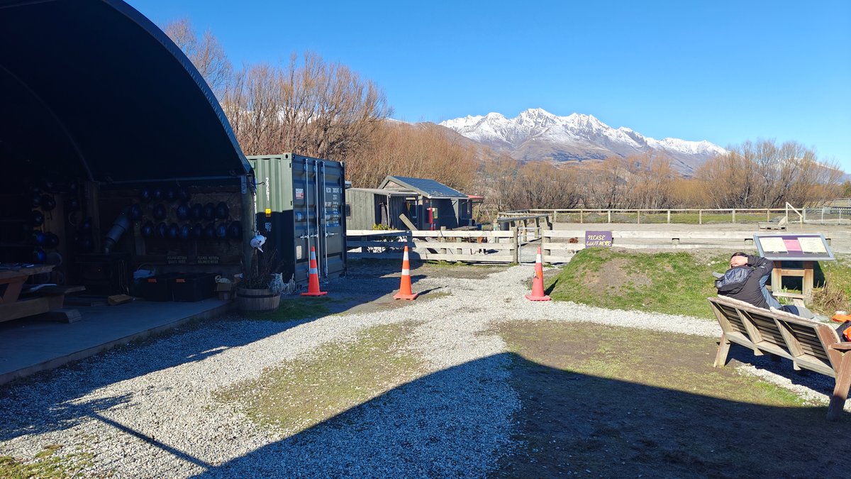 Exterior view across the gravel yard toward the