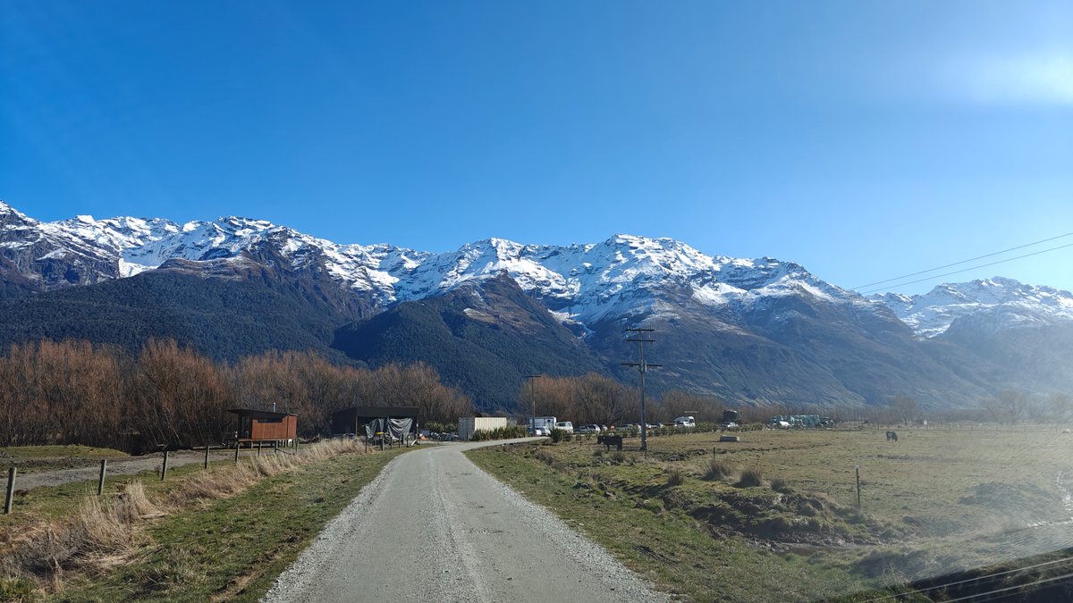 Farm road toward snow-capped range