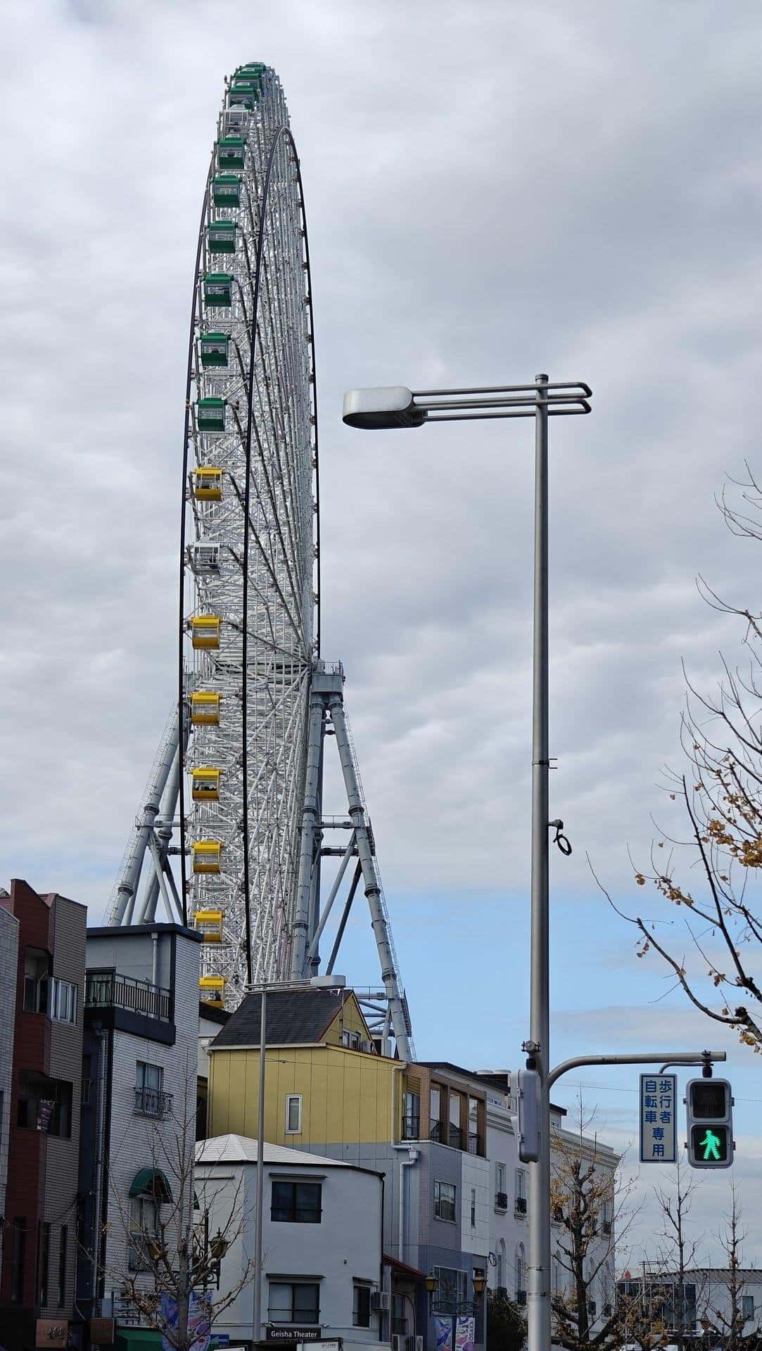 Ferris wheel above city buildings