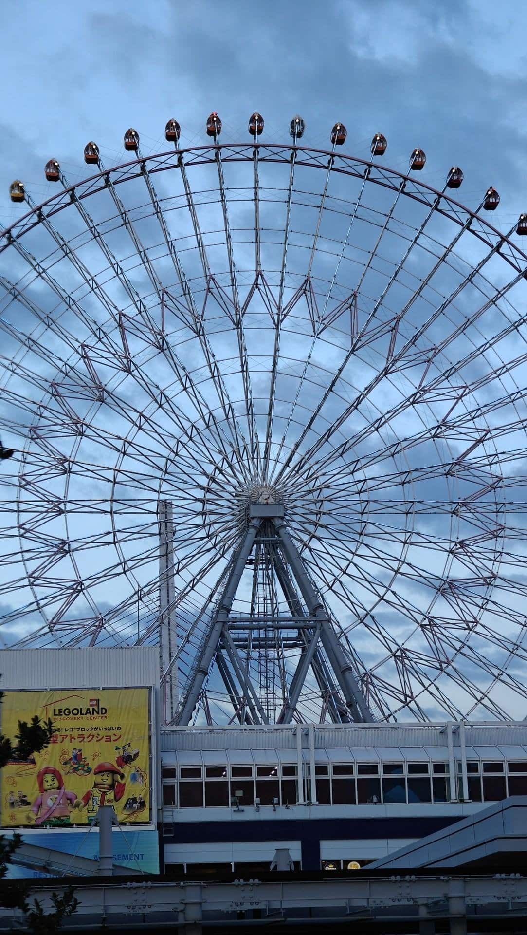 Ferris wheel against cloudy sky