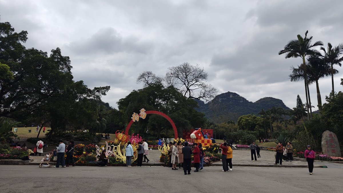 Festival grounds with colorful decorative arch and mountain