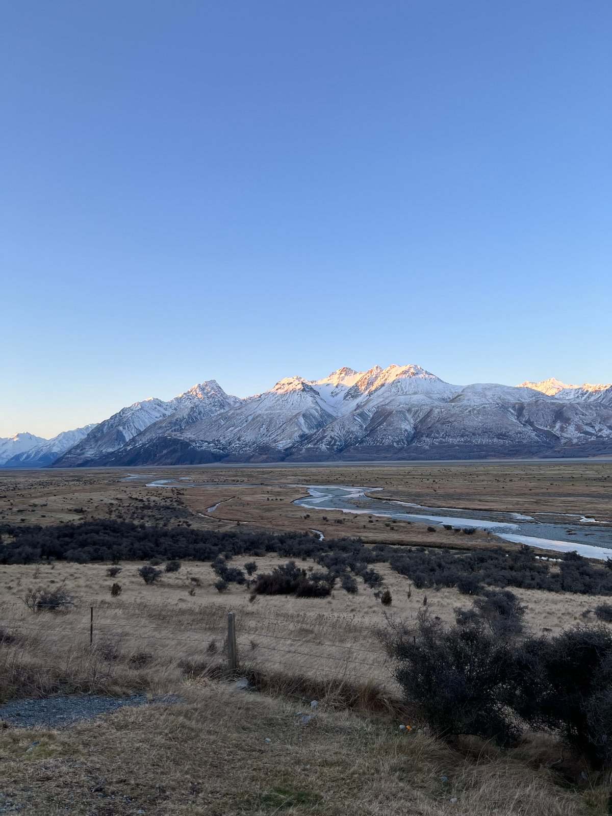 First light catching the snowy peaks above the