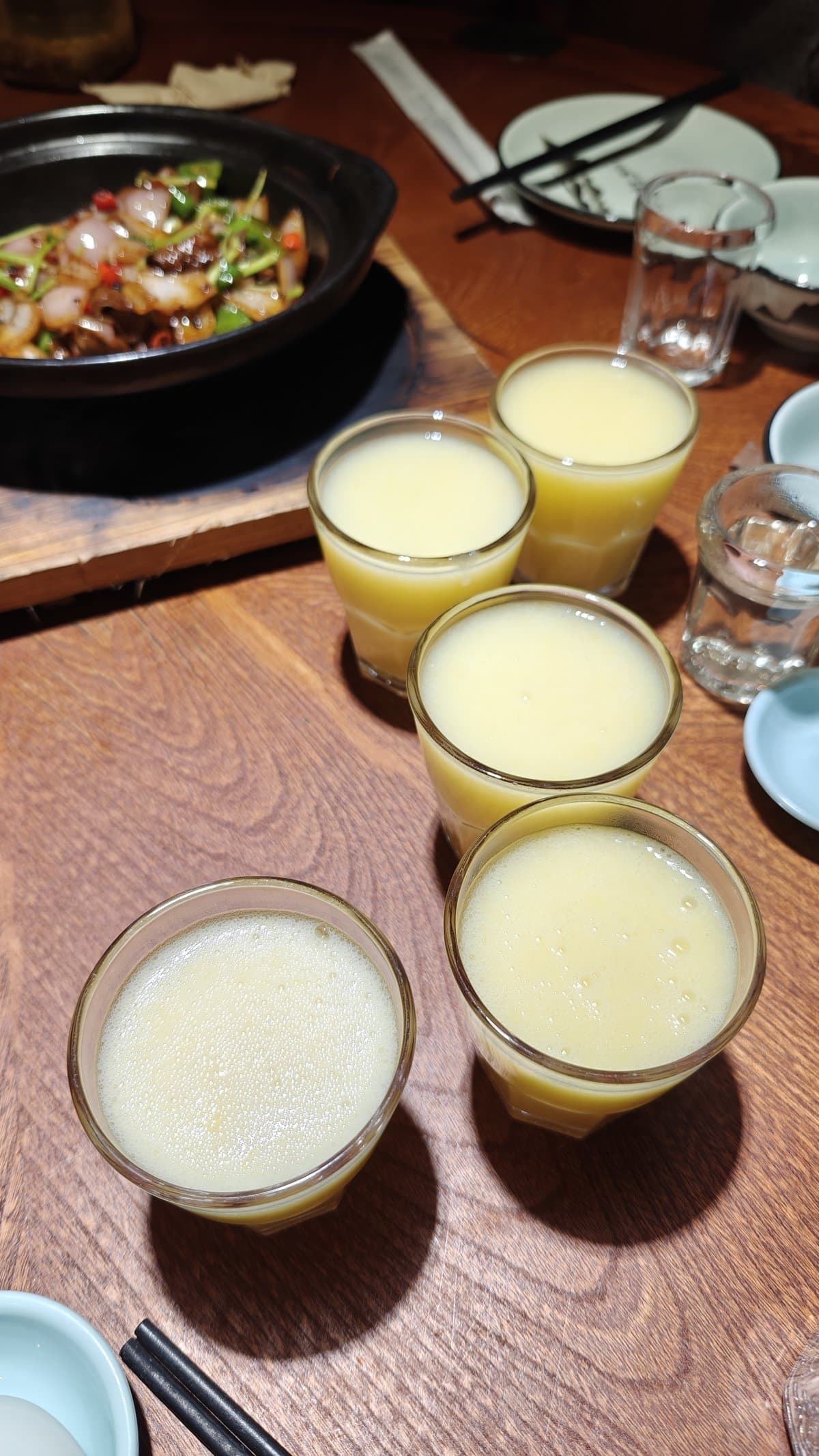 Five glasses of fresh corn juice on wooden