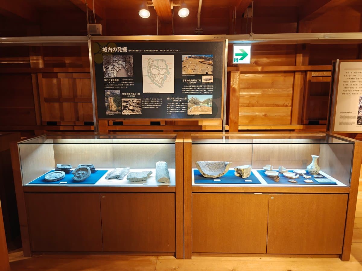 Glass display case of excavated artifacts (roof tiles,