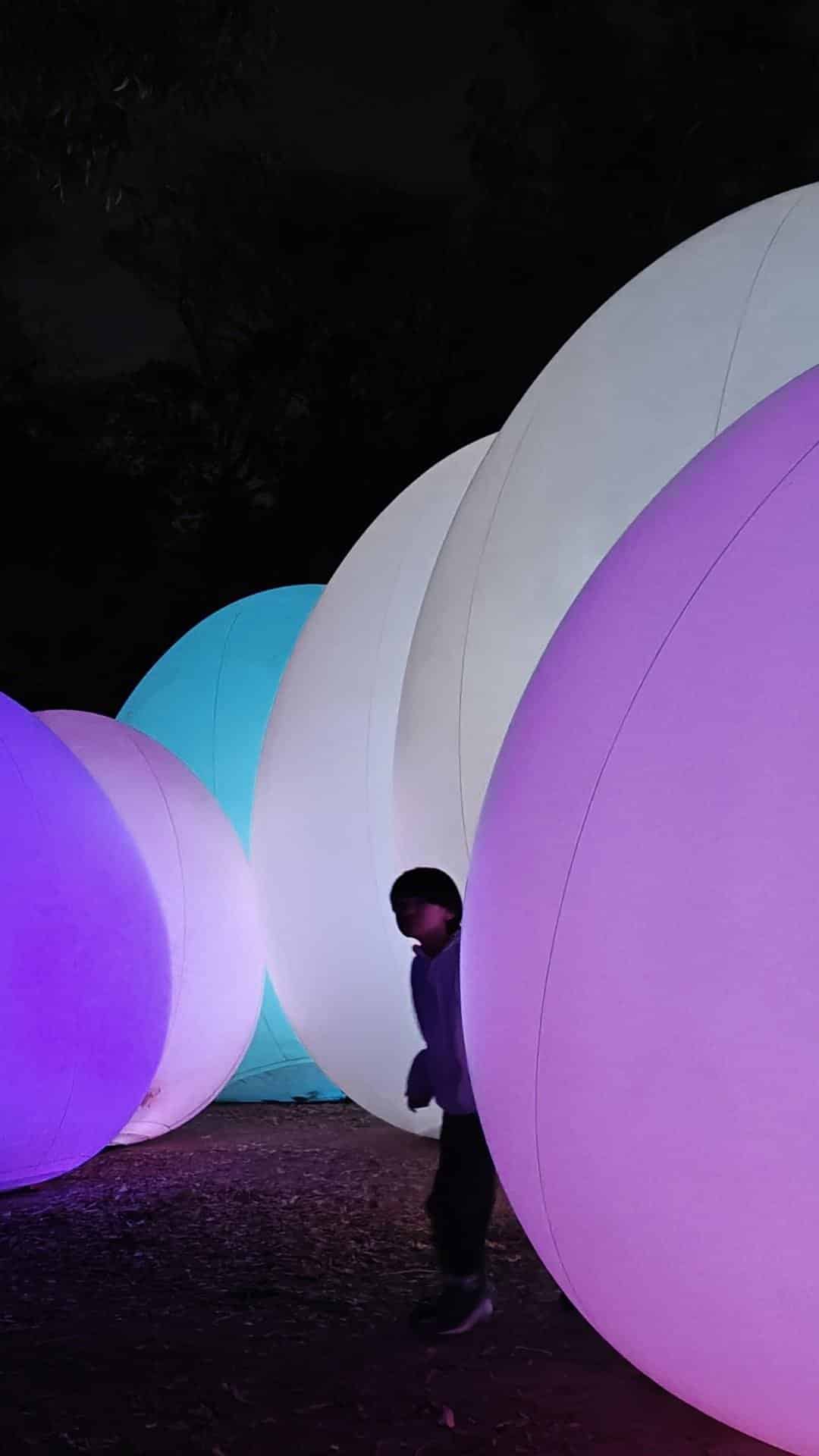Glowing colorful spheres at night