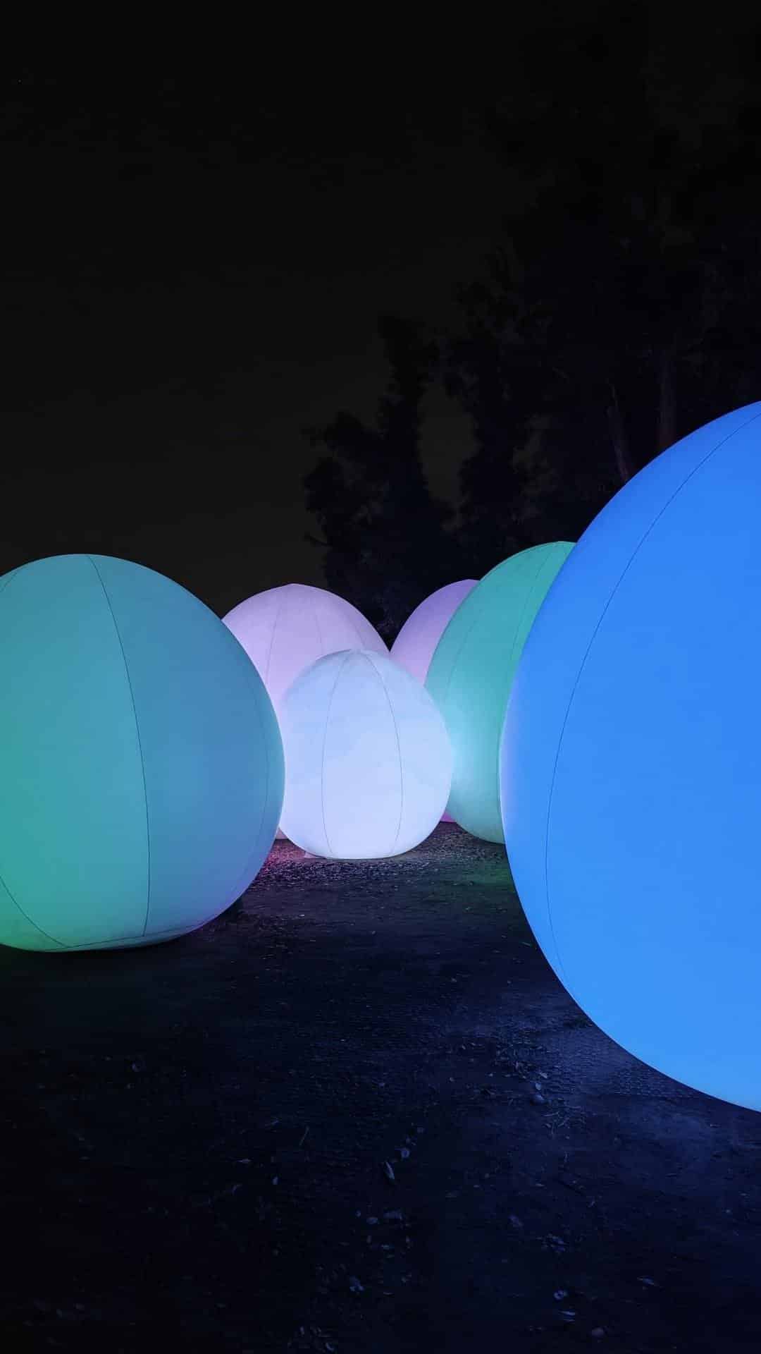 Glowing spheres in dark landscape