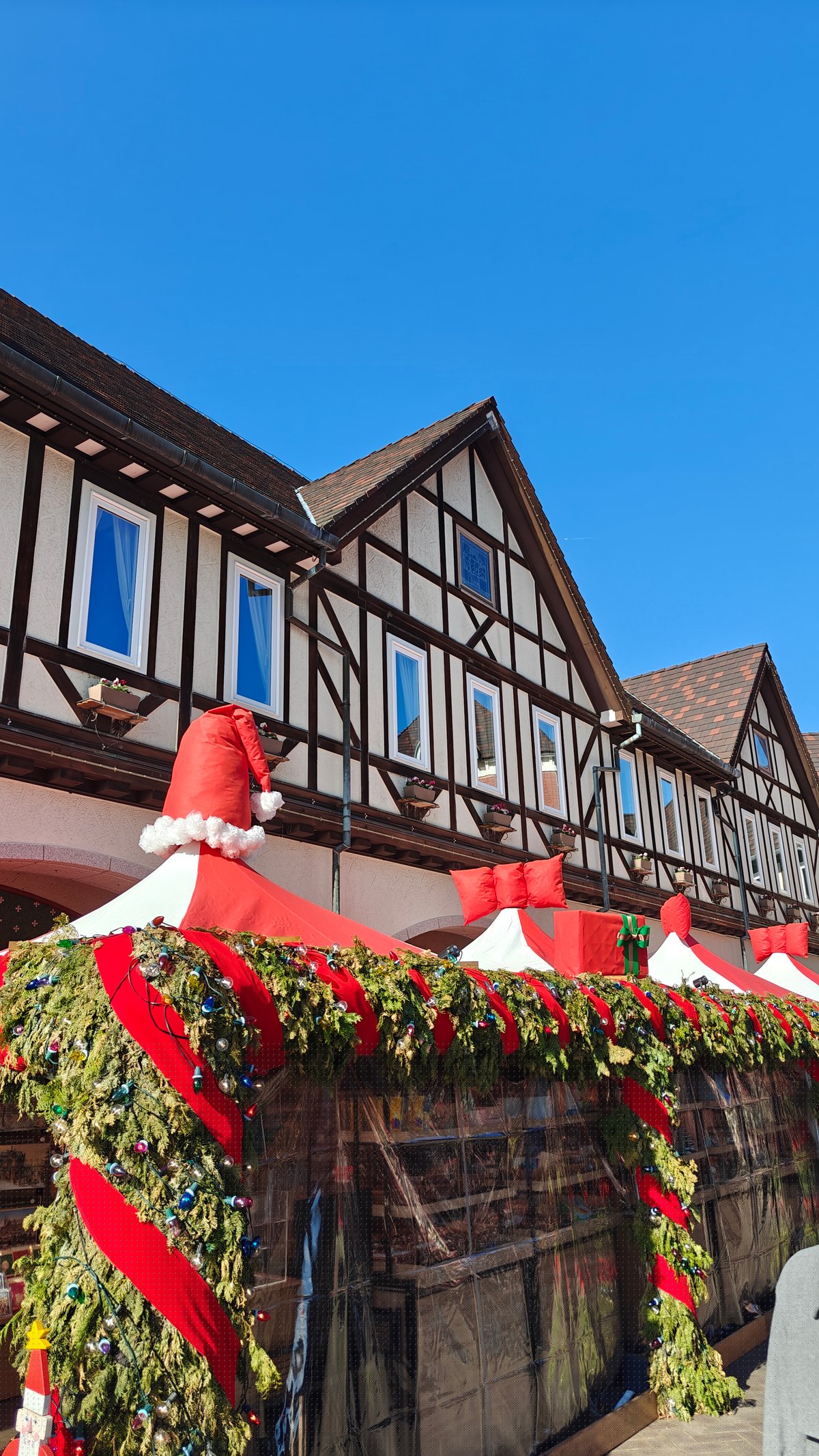Half-timbered building trimmed with a Christmas garland and