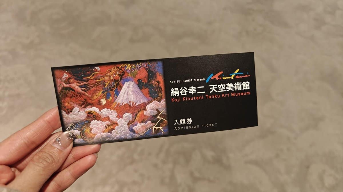 Hand holding art museum ticket