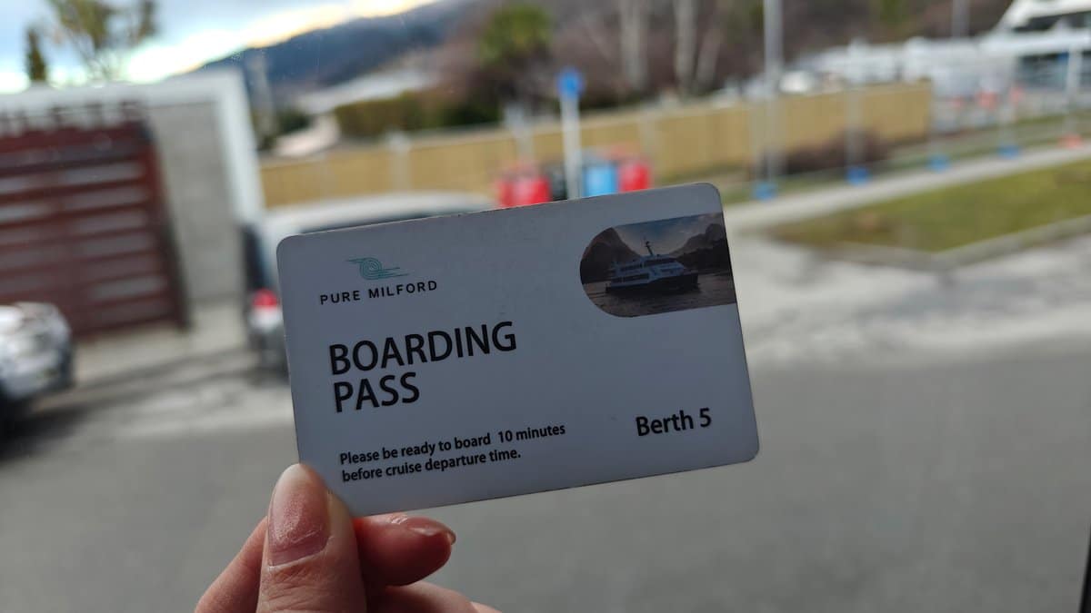 Hand holding the Pure Milford 'BOARDING PASS -