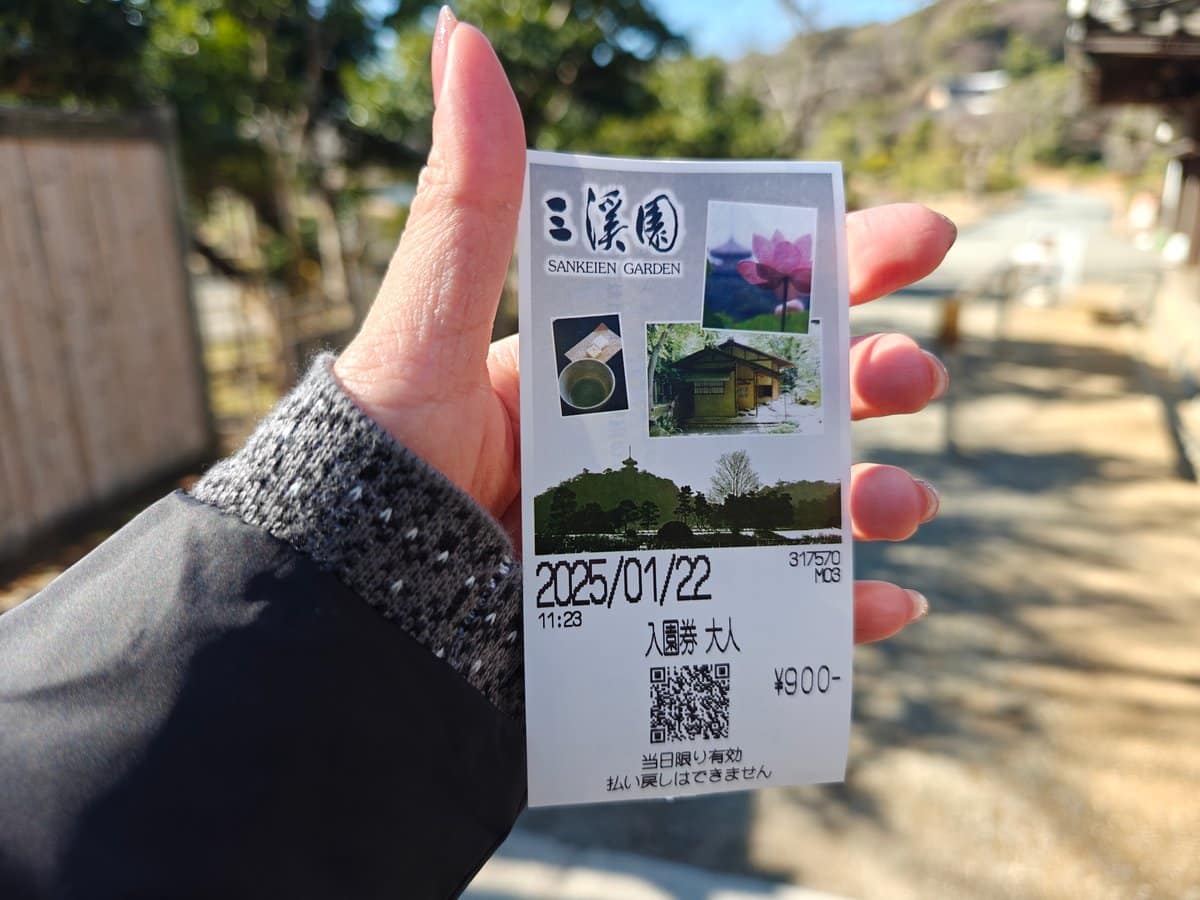 Hand holding the 三溪園 SANKEIEN GARDEN admission ticket