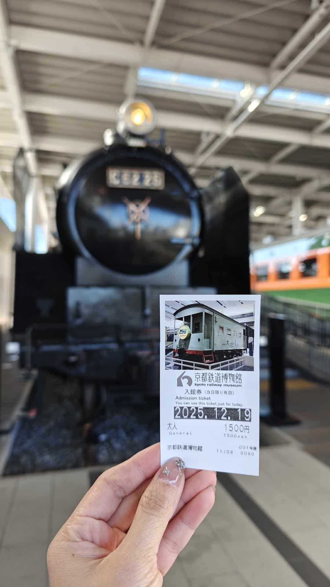 Hand holding train museum ticket