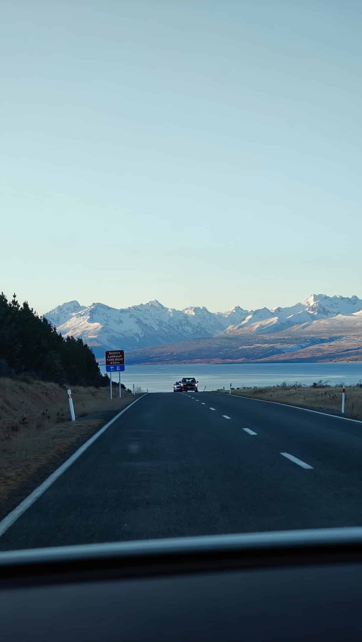 Highway descending to glacial lake