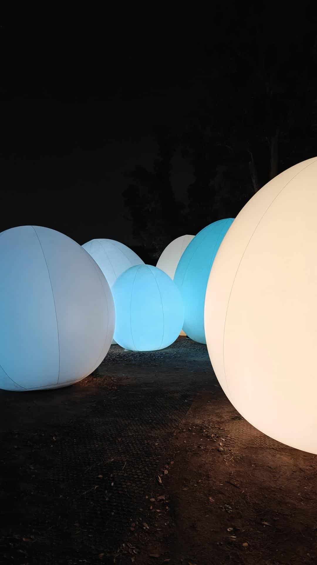 Illuminated spheres at night