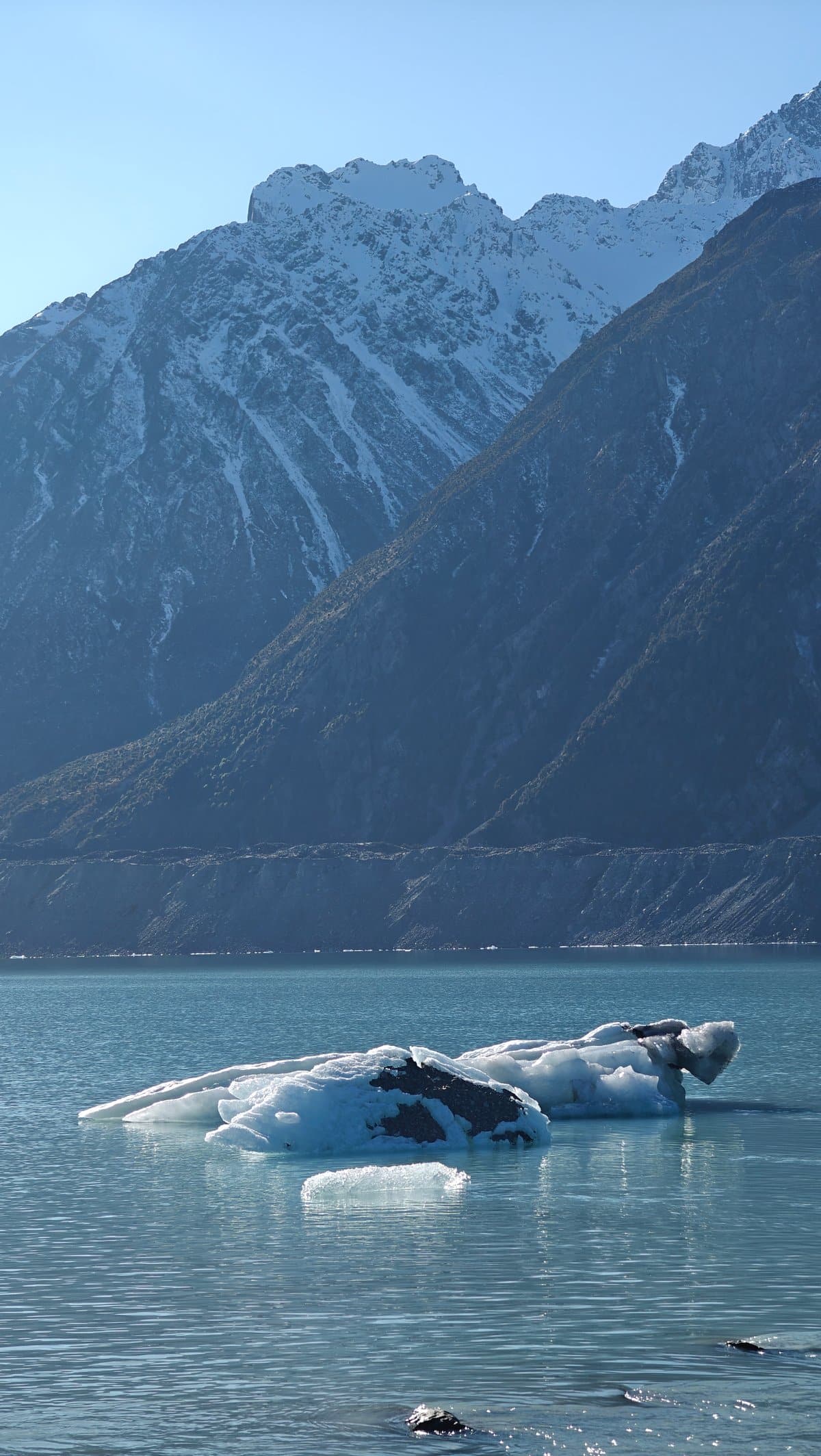 Jagged white iceberg on turquoise water