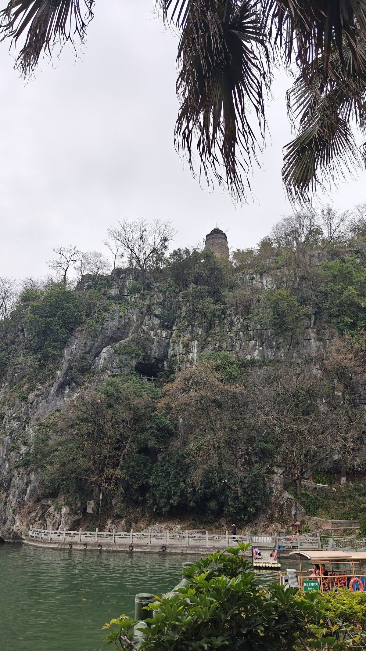 Karst hillside with pagoda on top, viewed through
