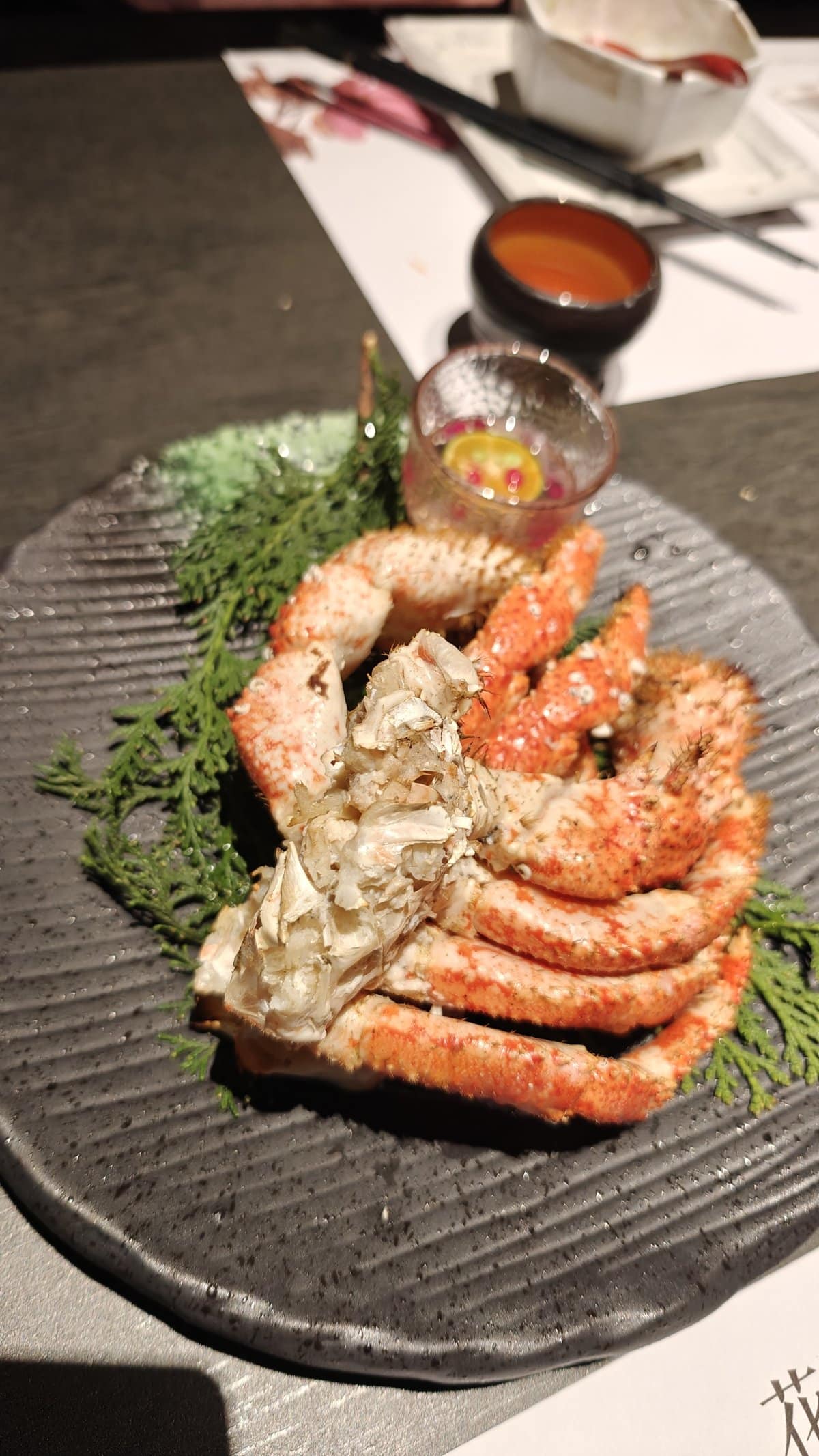 King crab legs on black plate
