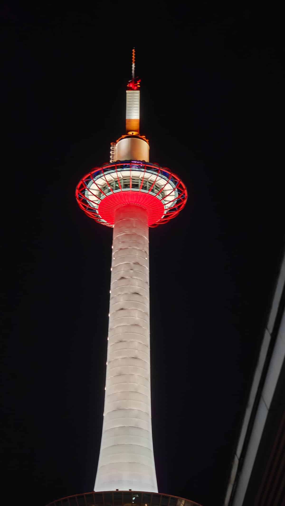 Kyoto Tower glowing red at night