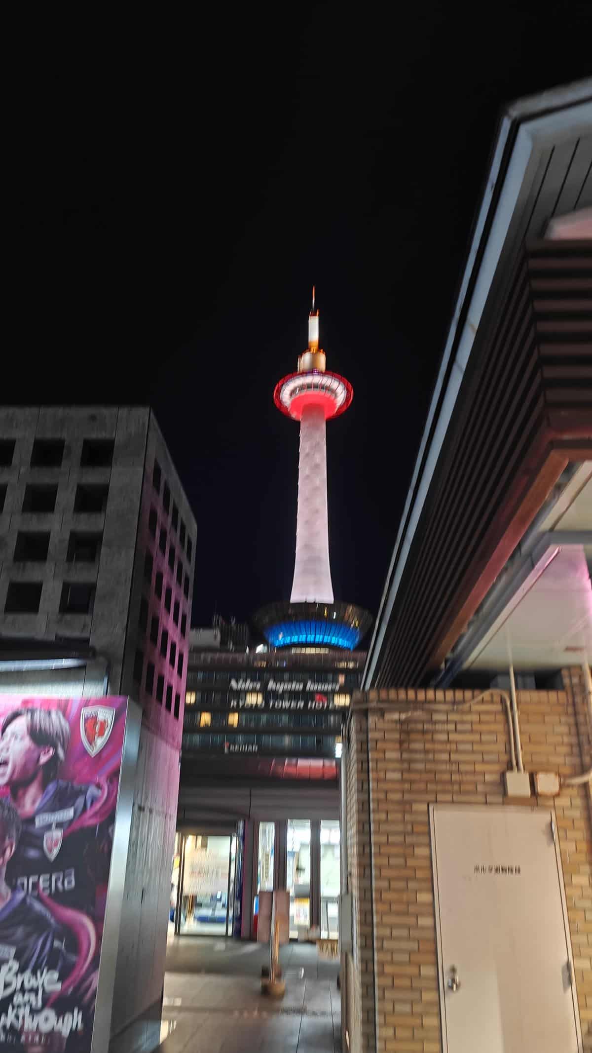 Kyoto Tower rising between buildings near the station