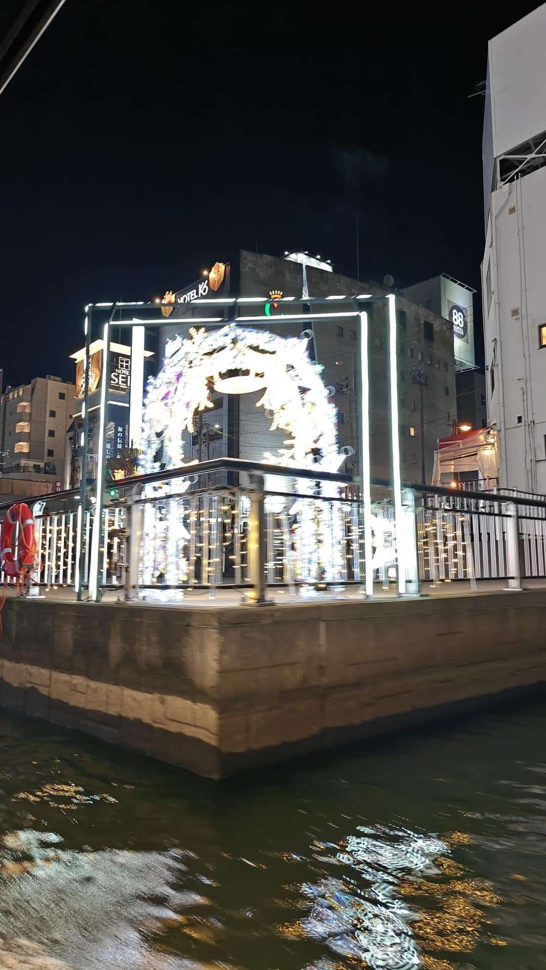 Lit archway by nighttime river