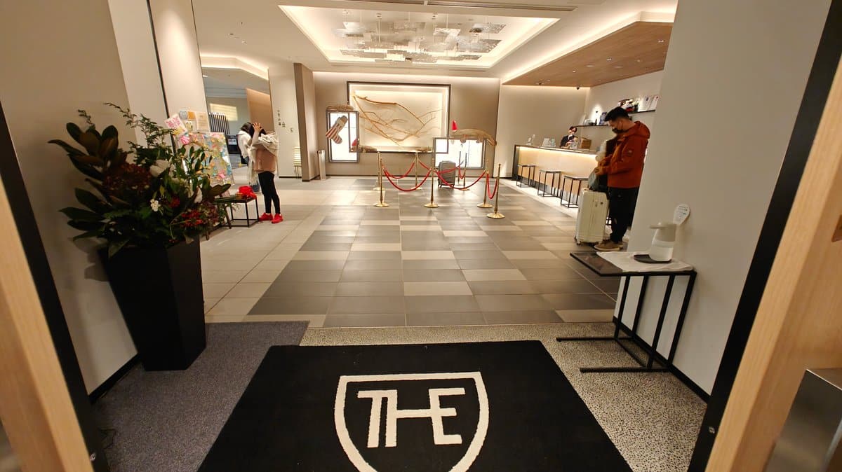 Lobby with the 'THE' logo inlaid in the