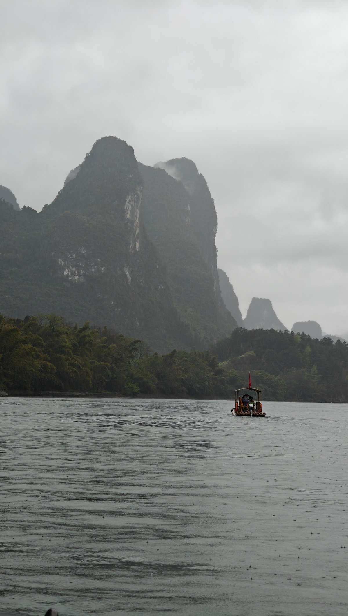 Lone raft on misty grey water