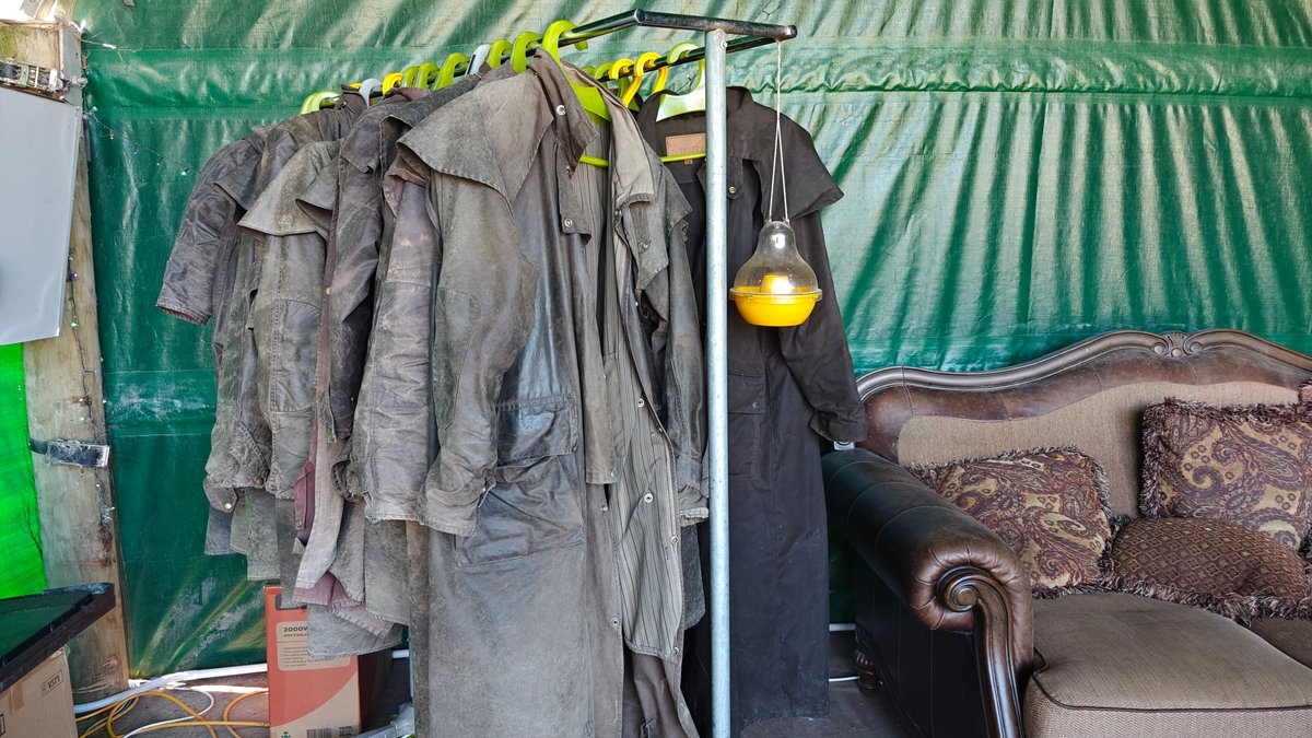 Long waxed oilskin (Driza-Bone style) coats hanging on
