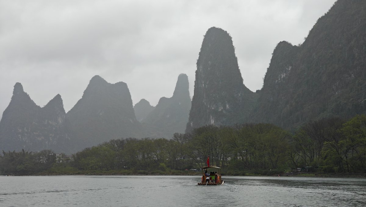 Misty panorama with tiny raft