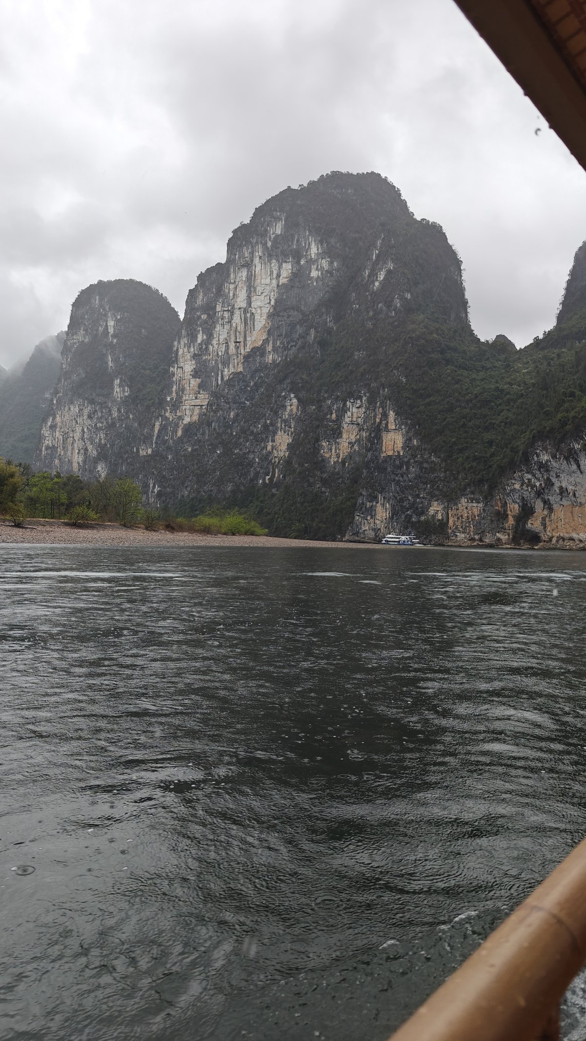 Moody tall cliffs over dark water