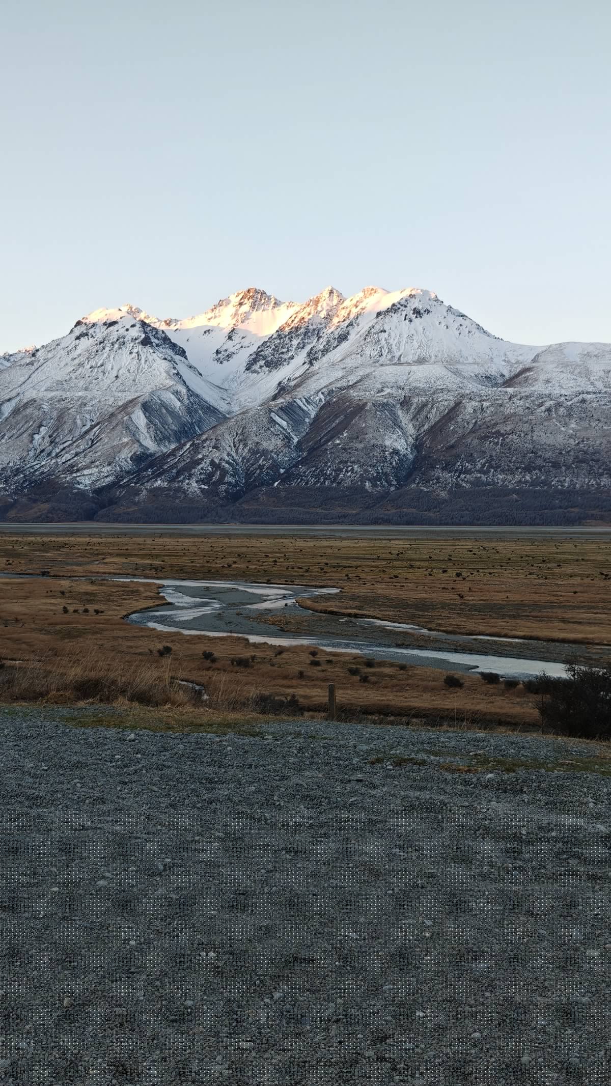 Mountain valley with a braided river threading pale