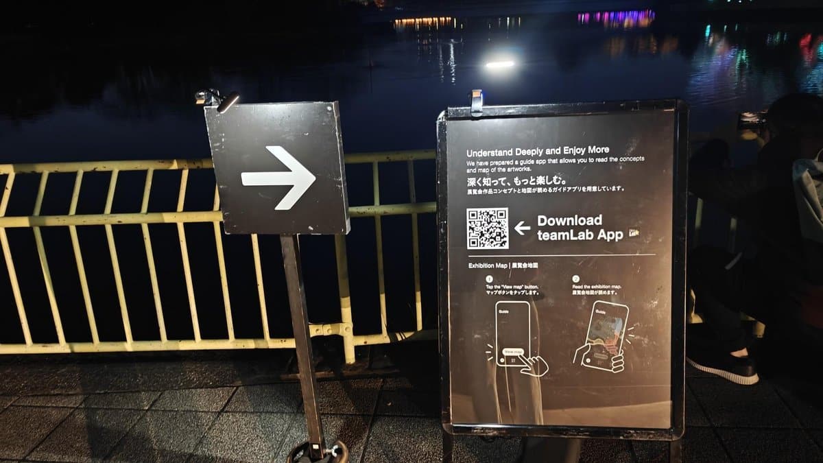 Night sign with QR code near water