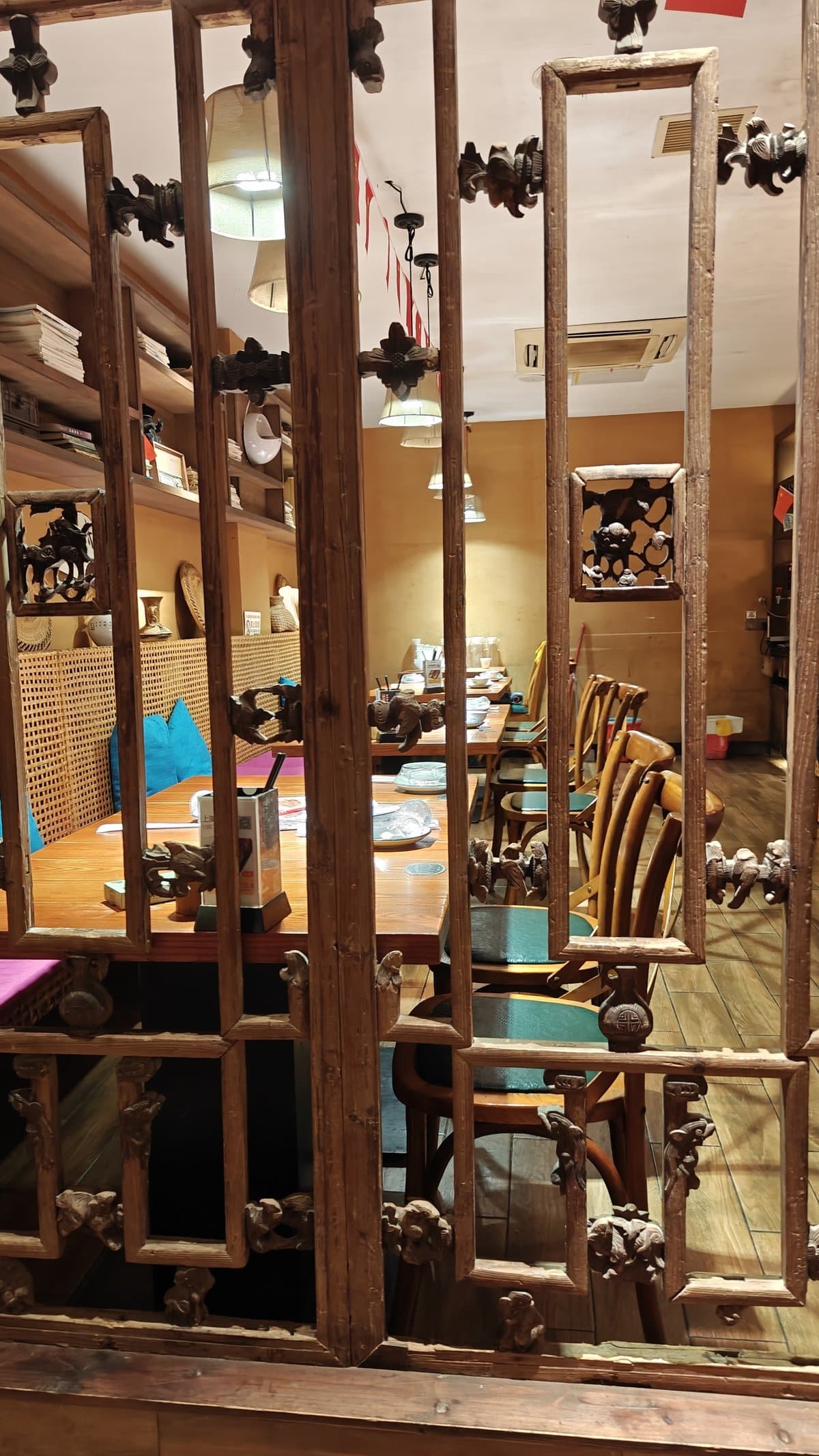 Ornate wooden partition with carved decorations dividing the