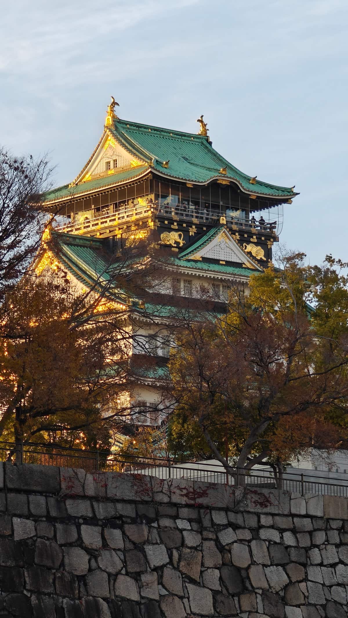 Osaka Castle tower through trees