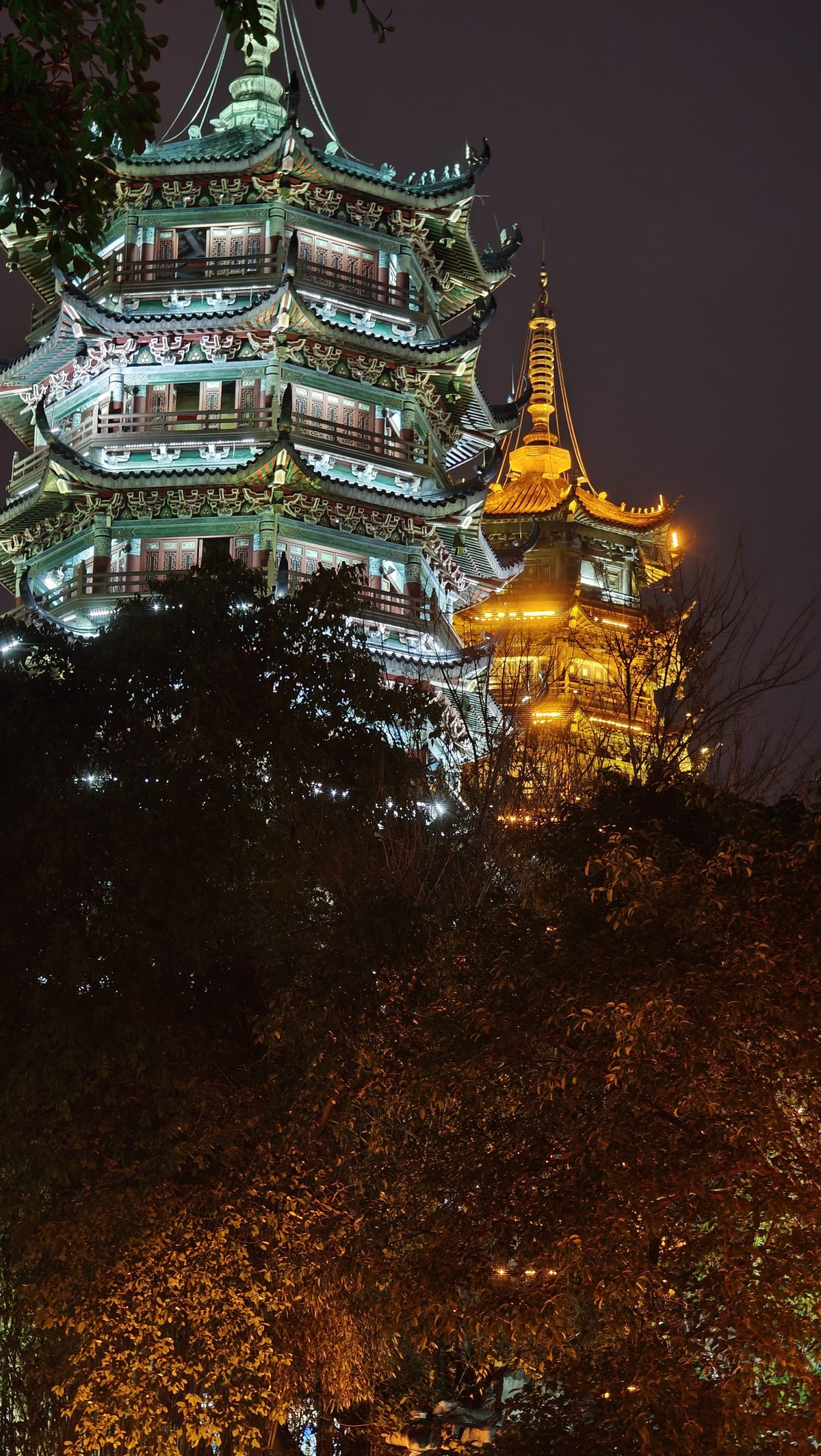 Pagodas through autumn tree canopy