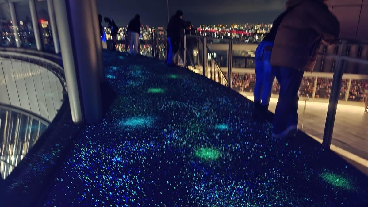 People on illuminated observation deck