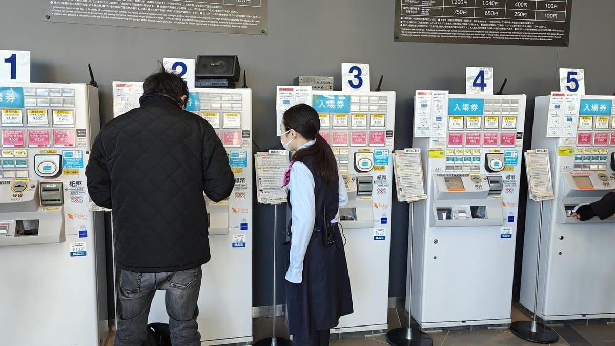 People using ticket machines indoors