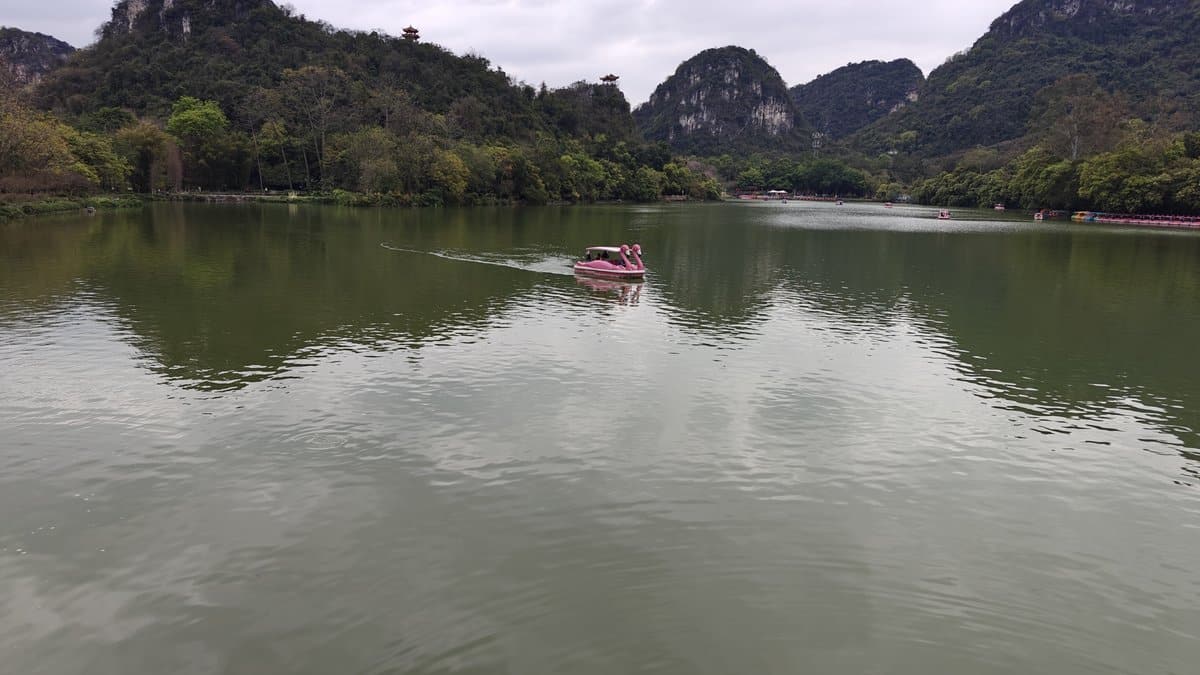 Pink boat dramatic mountain backdrop