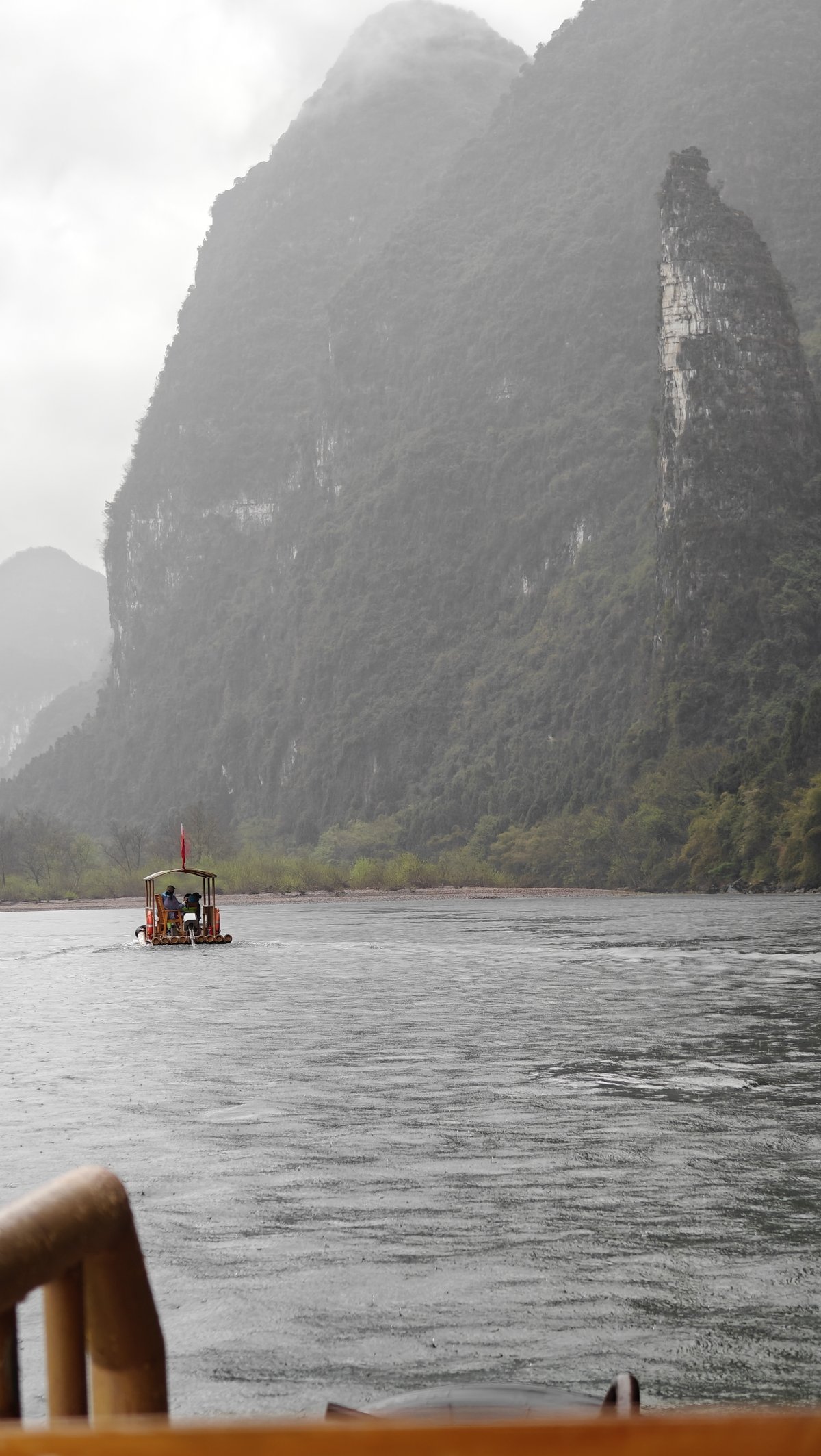 Raft dwarfed by massive peak