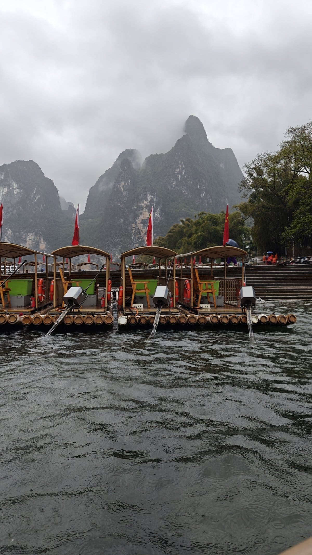 Rafts lined at misty shoreline