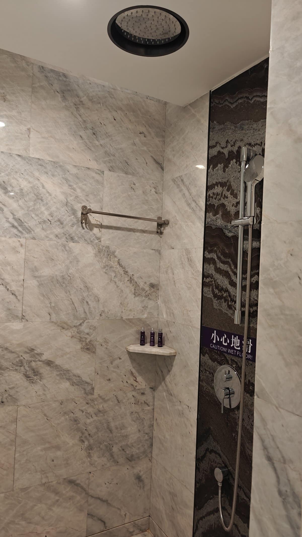 Rain shower marble walls toiletries