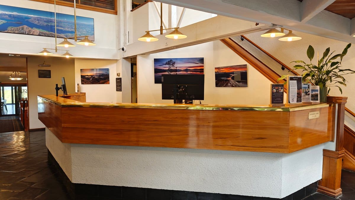Reception desk inside the lobby: a curved timber-clad
