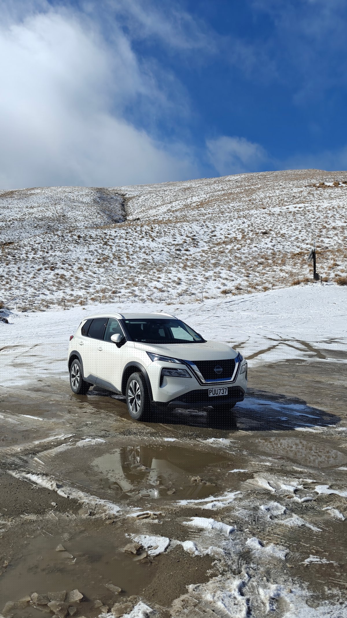 Rental X-Trail parked in snow